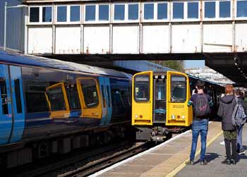 young boys taking photographing railtour 313 201 and unidentified trains.