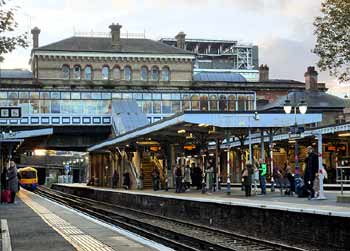 London Overground train departs from Denmark Hill station.