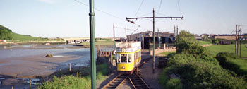 riverside scene with tram.