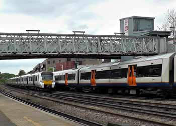 Thameslink train passes London Overground train at Brockley station.